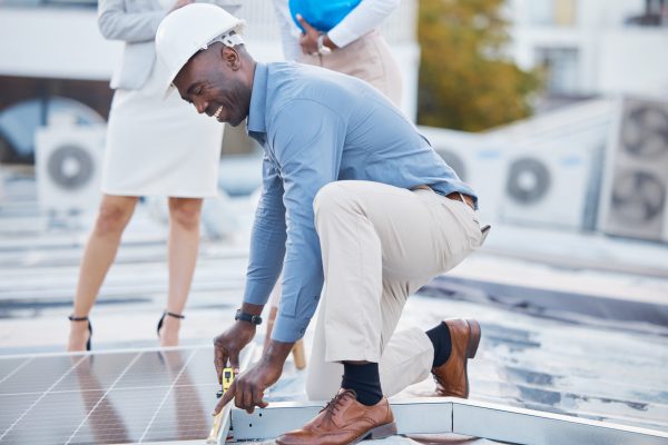 Black man, engineer and solar panel grid installation of construction worker technician outdoor. Bu.